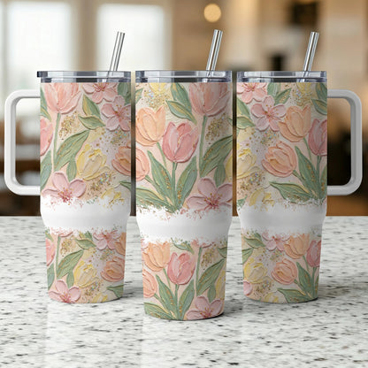Three floral tumblers with tulips, watercolor style, on a speckled countertop.