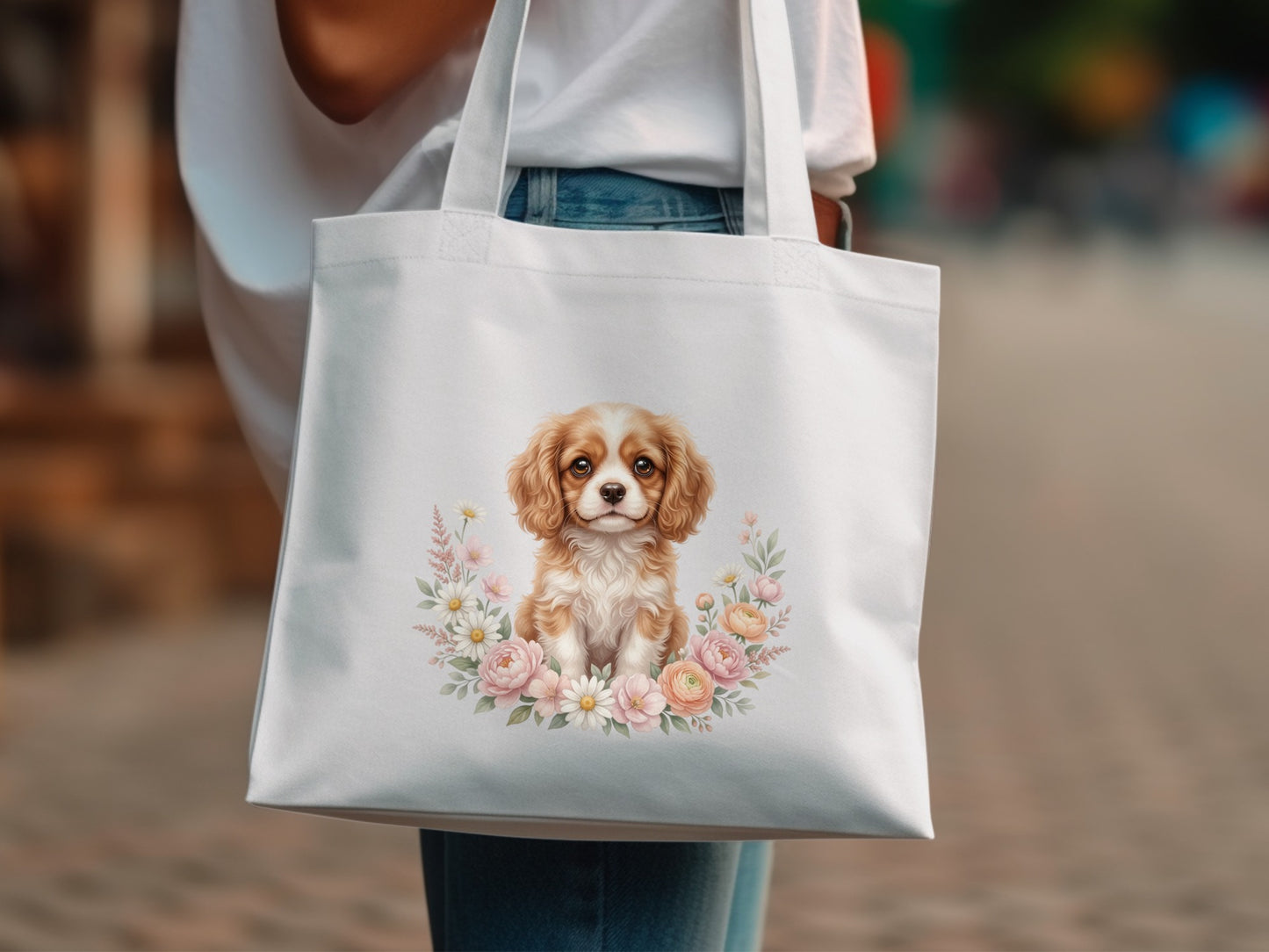 White tote bag with a Cavalier King Charles Spaniel illustration in a floral wreath.