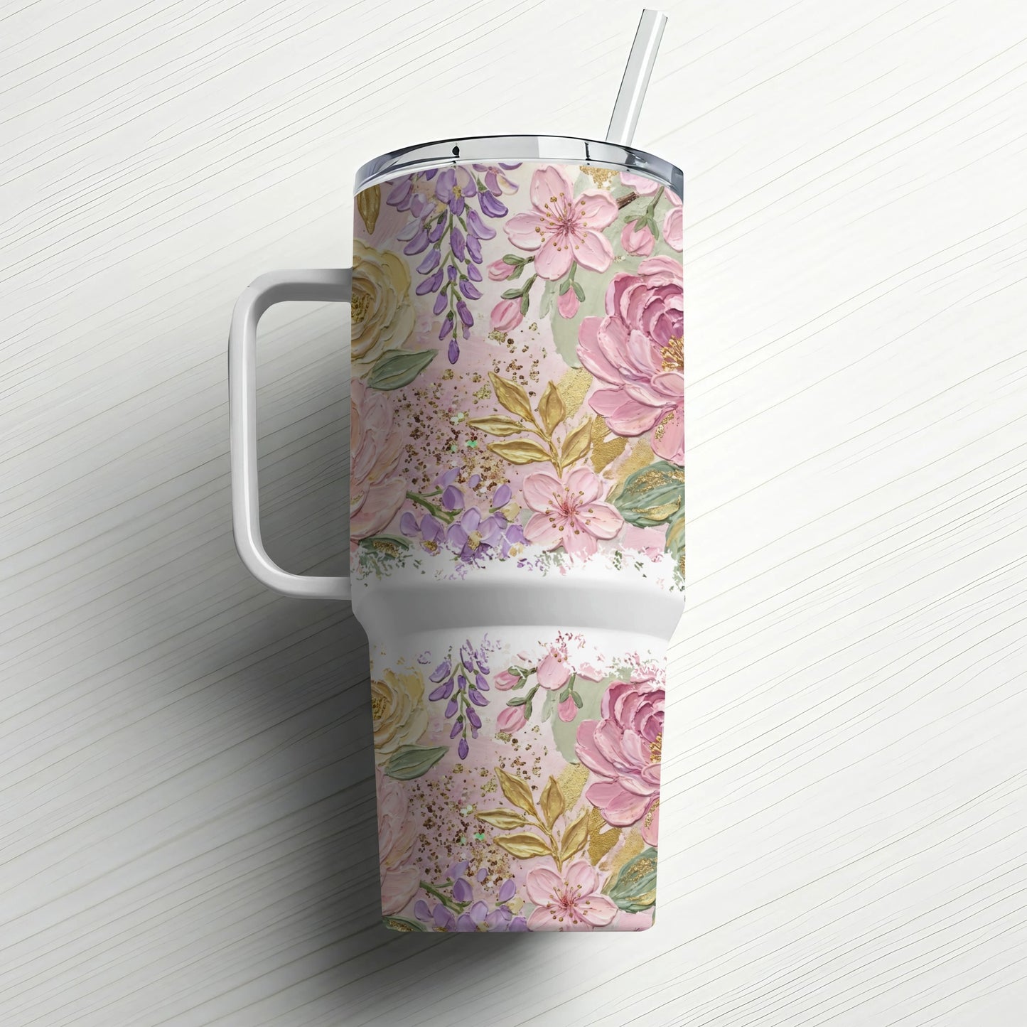 White tumbler with a floral pattern of pink and purple flowers and gold accents.