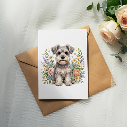 Schnauzer dog surrounded by flowers on a greeting card.
