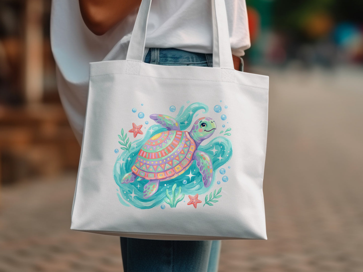 White tote bag with colorful cartoon sea turtle and starfish design.