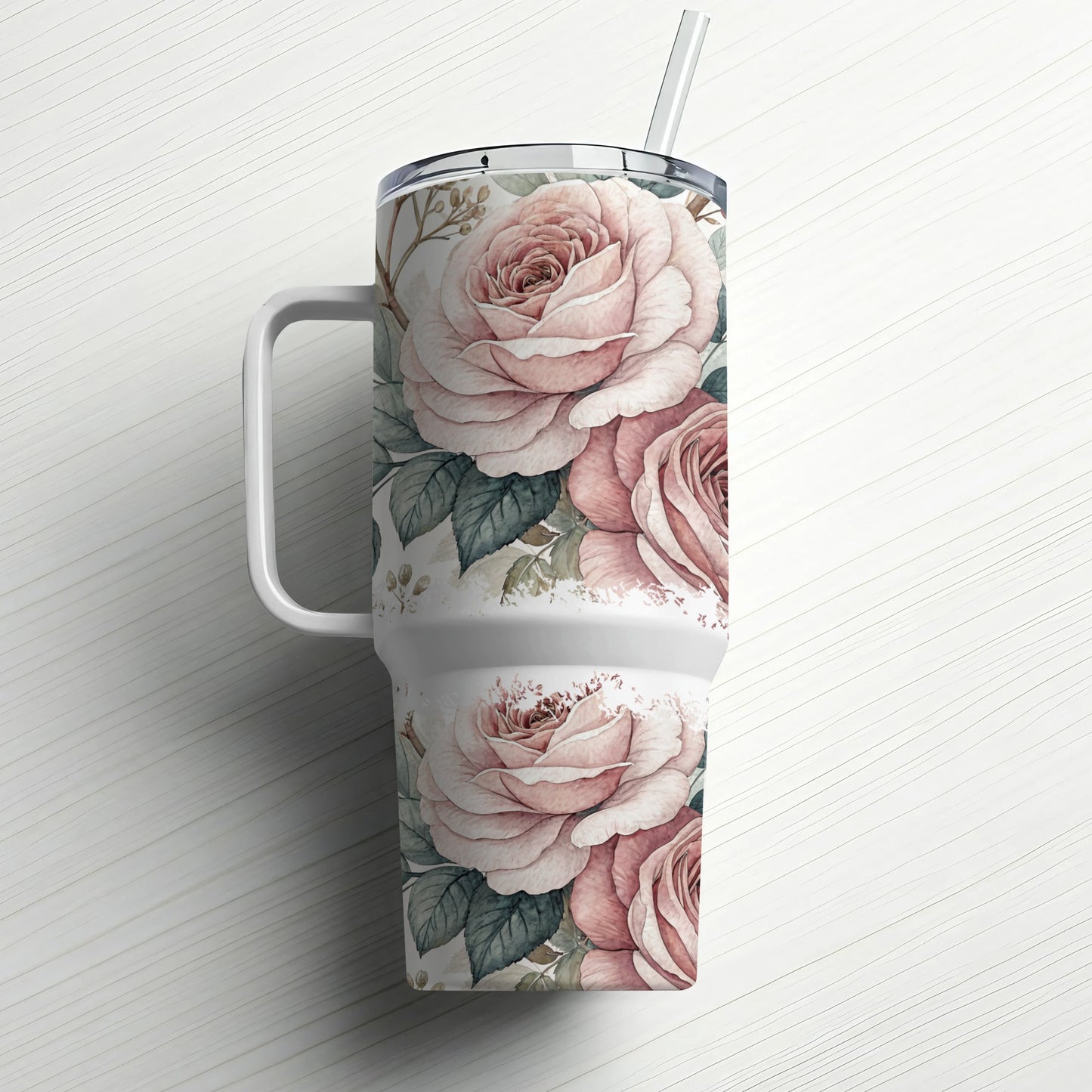 White tumbler with pink roses and a straw.