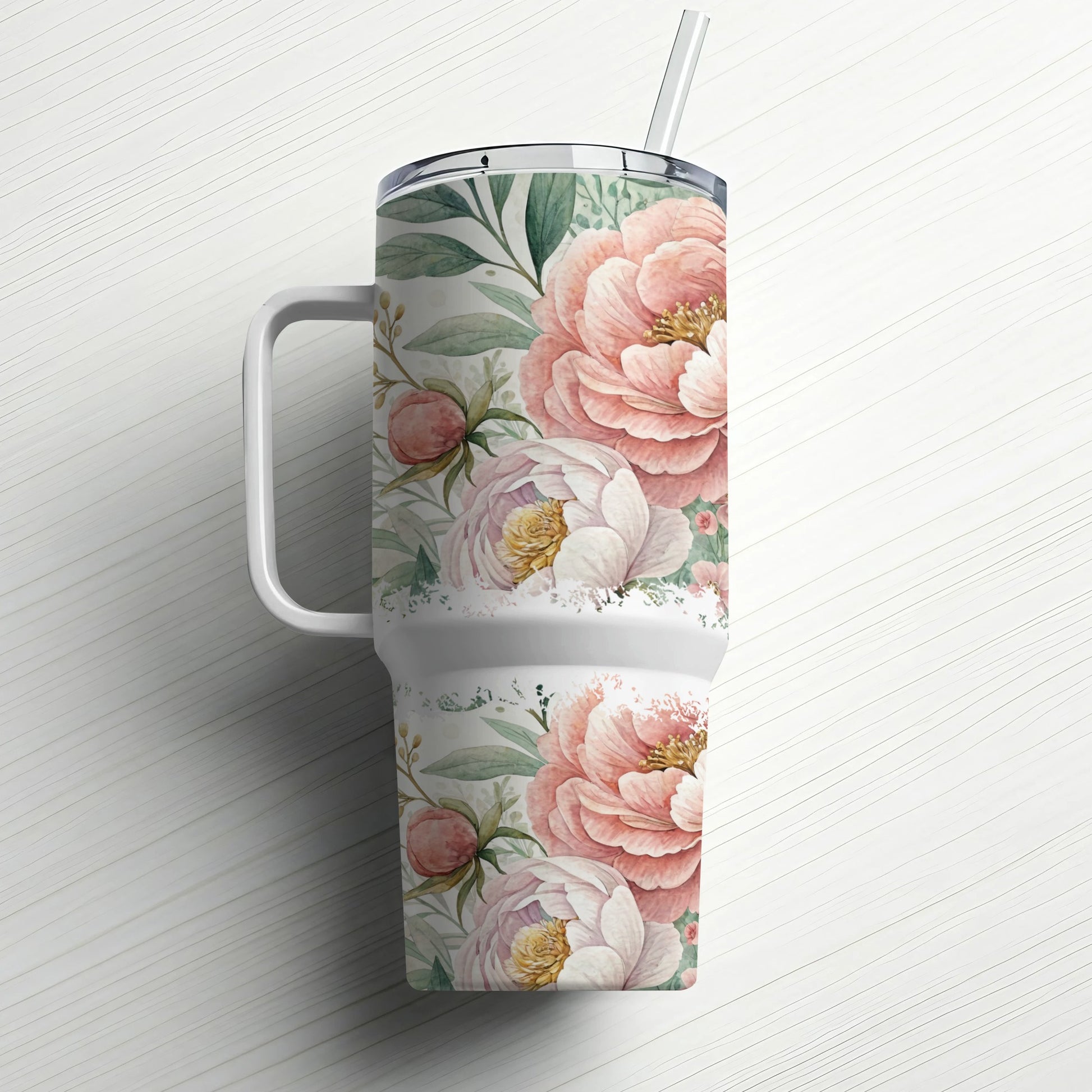White tumbler with pink peonies and green leaves, and a straw.