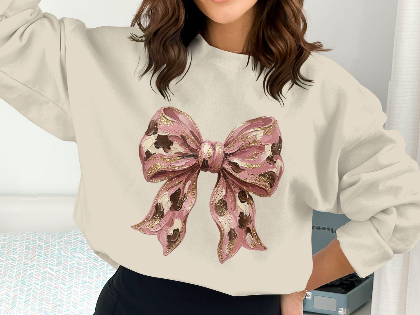 Cream sweatshirt with a pink leopard print bow graphic and glitter details.