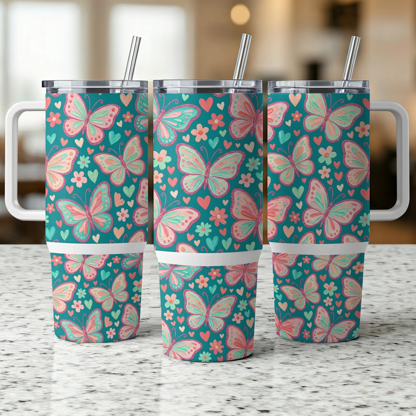 Three teal tumblers with pink and orange butterfly and flower patterns.