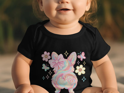 Baby wearing black onesie with pastel puppy, bow, and butterflies.