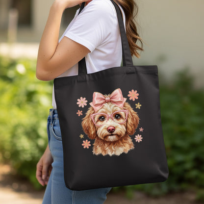 Black tote bag with a graphic of a poodle wearing glasses and a bow.