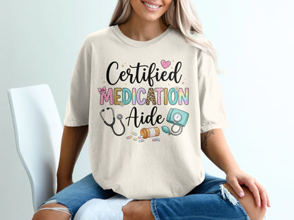 T-shirt with "Certified Medication Aide" text, stethoscope, and medical supplies.