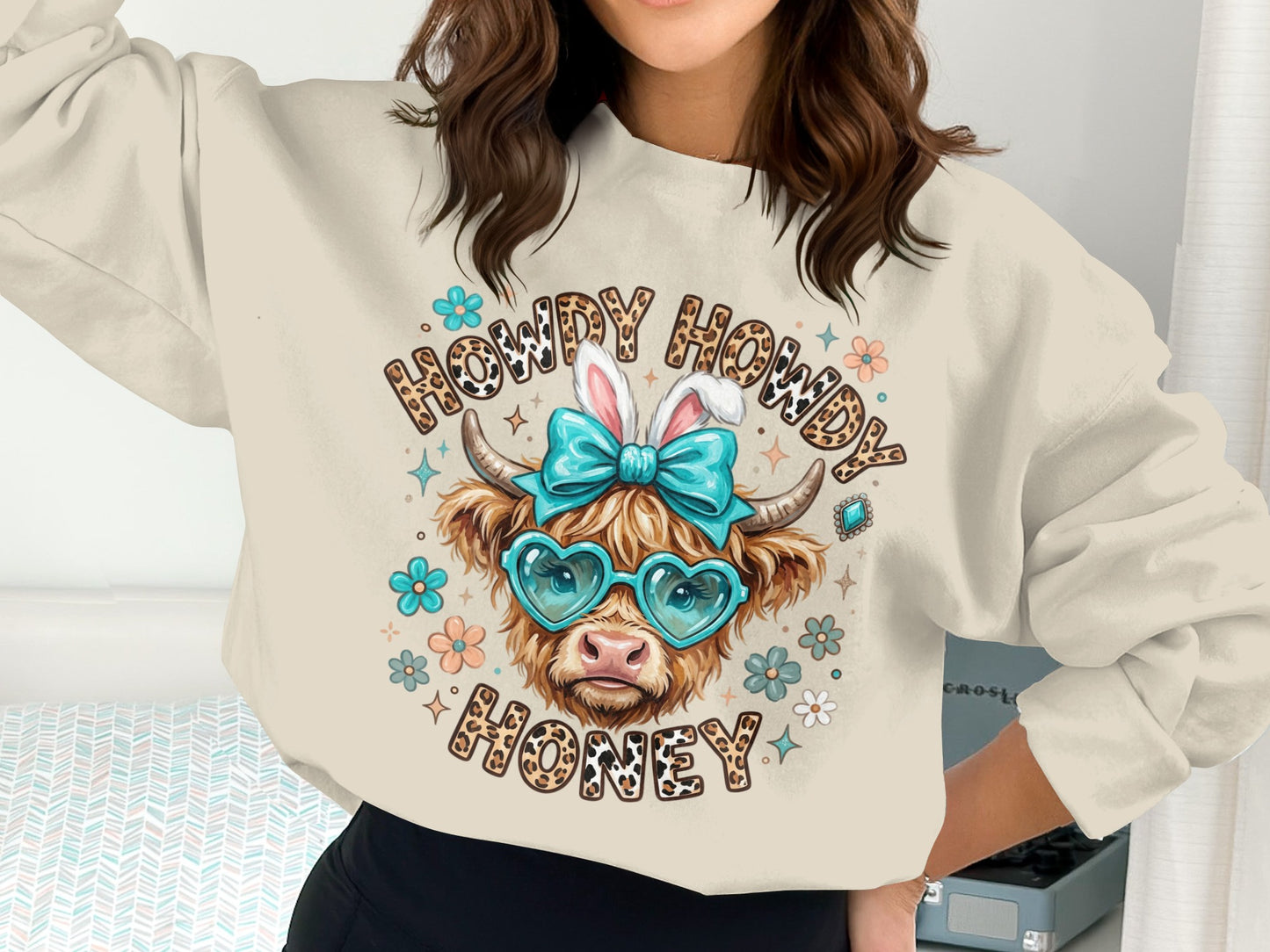 Cow wearing heart sunglasses and bunny ears on "Howdy Howdy Honey" sweatshirt.