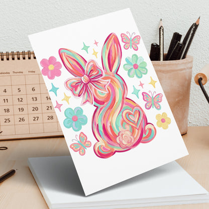 Colorful striped Easter bunny with a bow and butterflies on a calendar.
