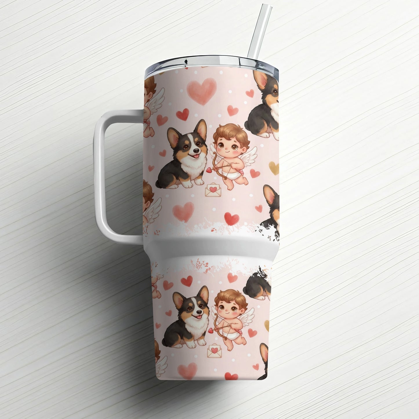 Pink tumbler with corgis and cherubs pattern, straw inserted.