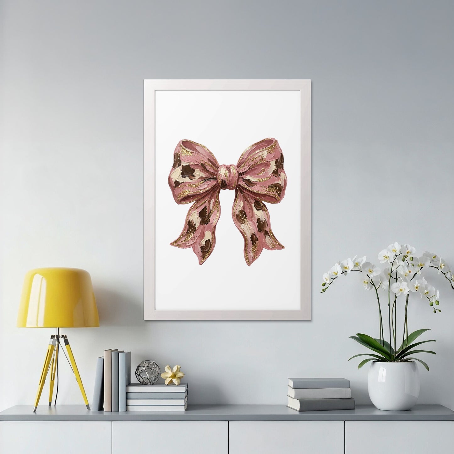 Pink bow illustration with gold accents in a white frame.