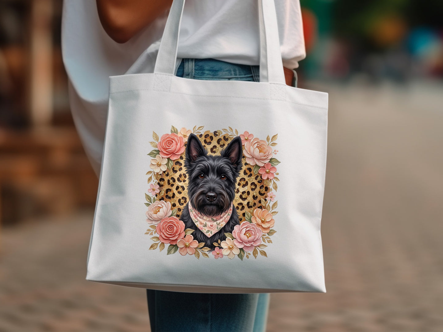 White tote bag with a Scottish Terrier portrait surrounded by floral accents.