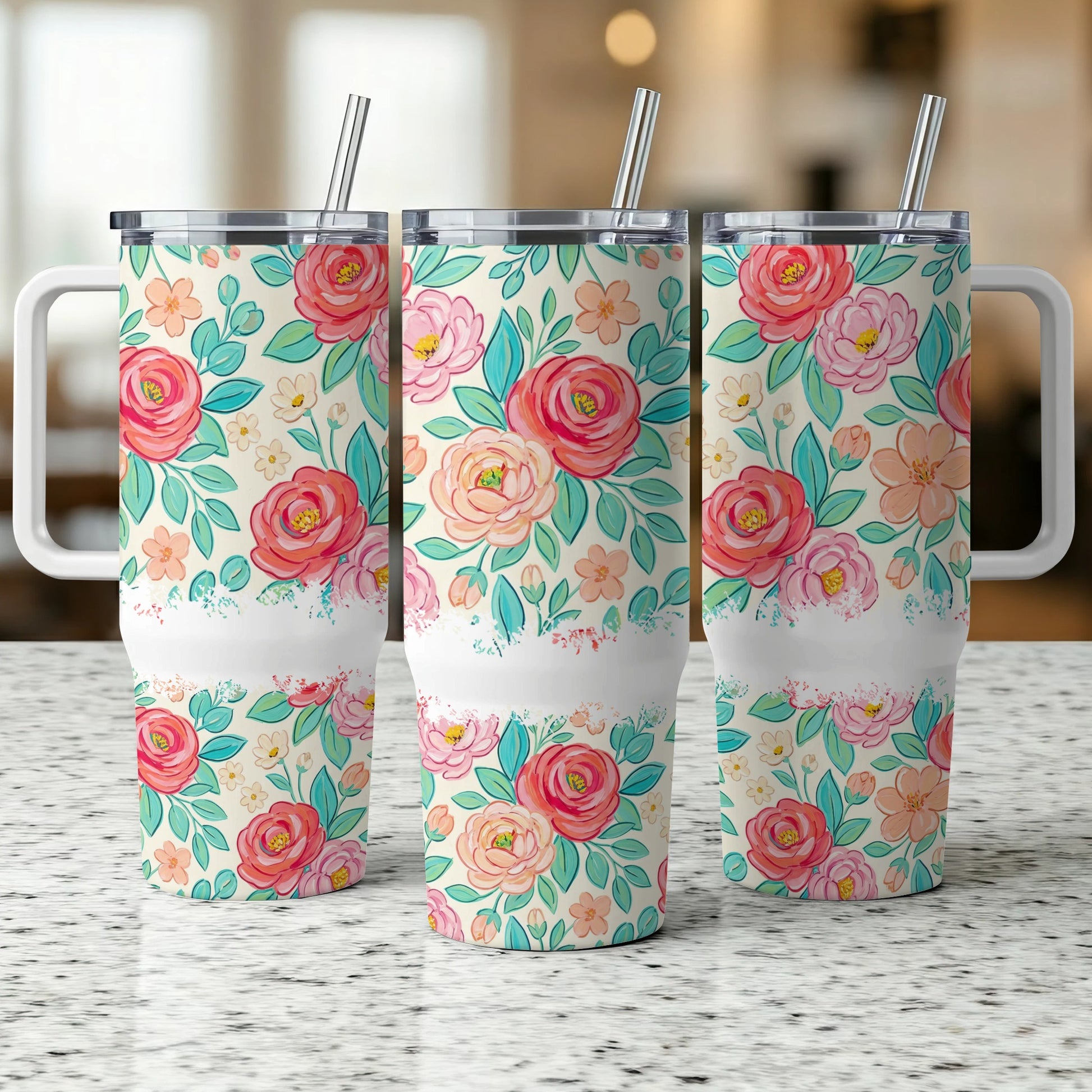 Three tumblers with a floral pattern and white handle and straw.