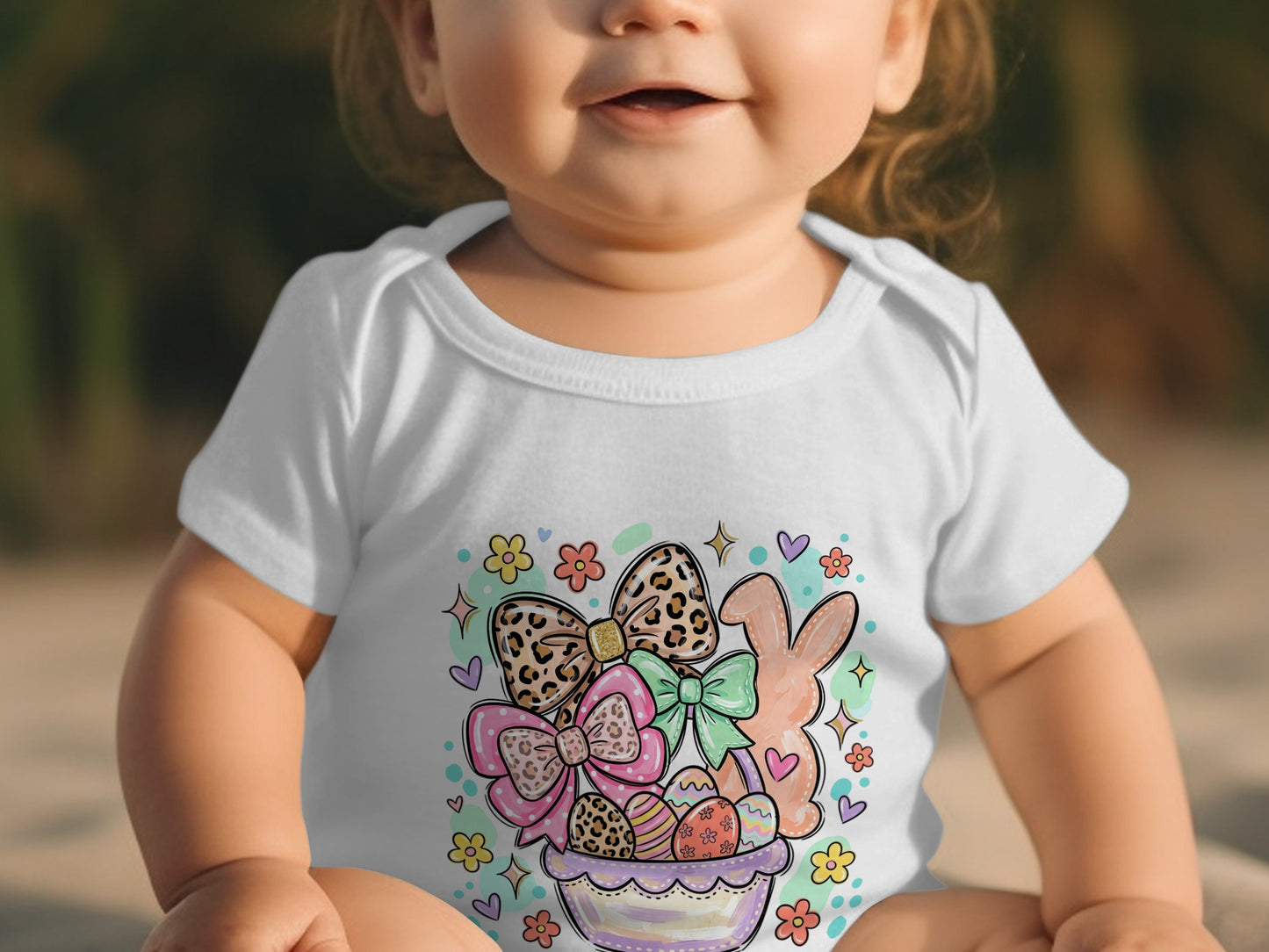 Baby in white onesie with Easter basket, bunny, and bows design.