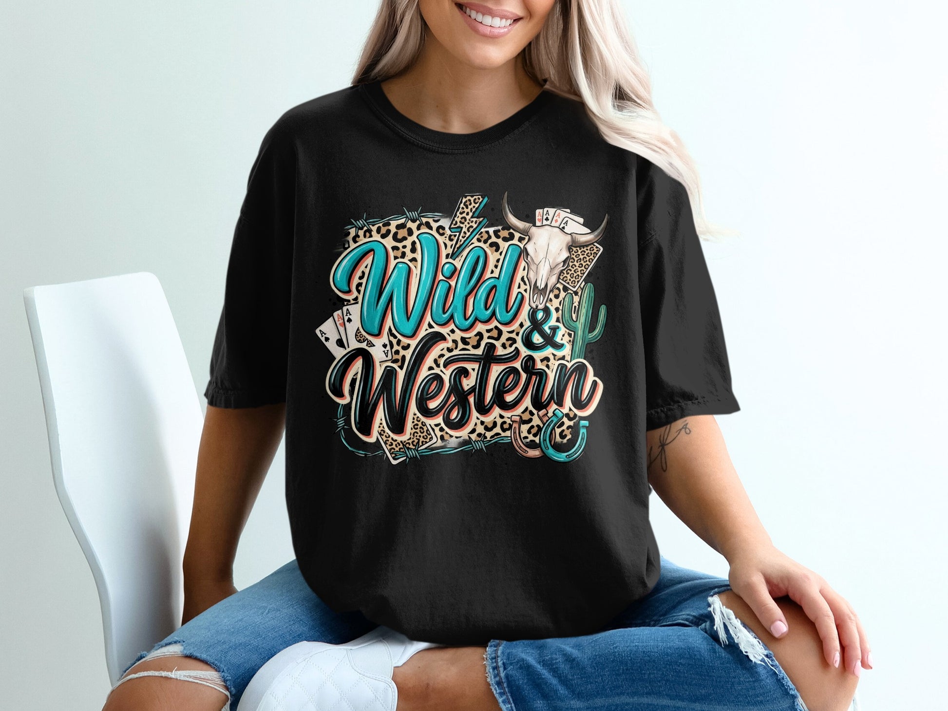 Black t-shirt with "Wild & Western" text, bull skull, cacti, and playing cards.