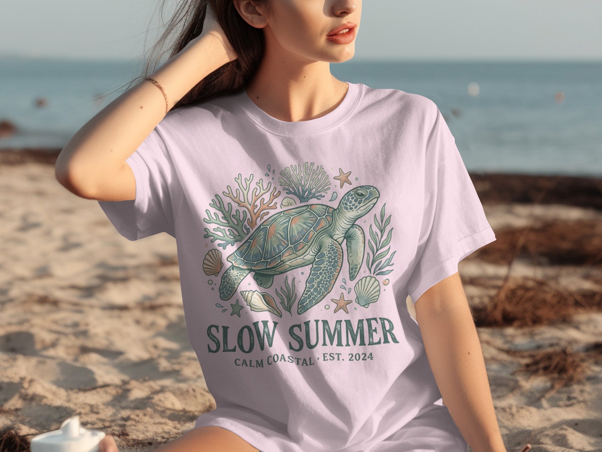 T-shirt with sea turtle, coral, and seashells graphic, reading "Slow Summer".