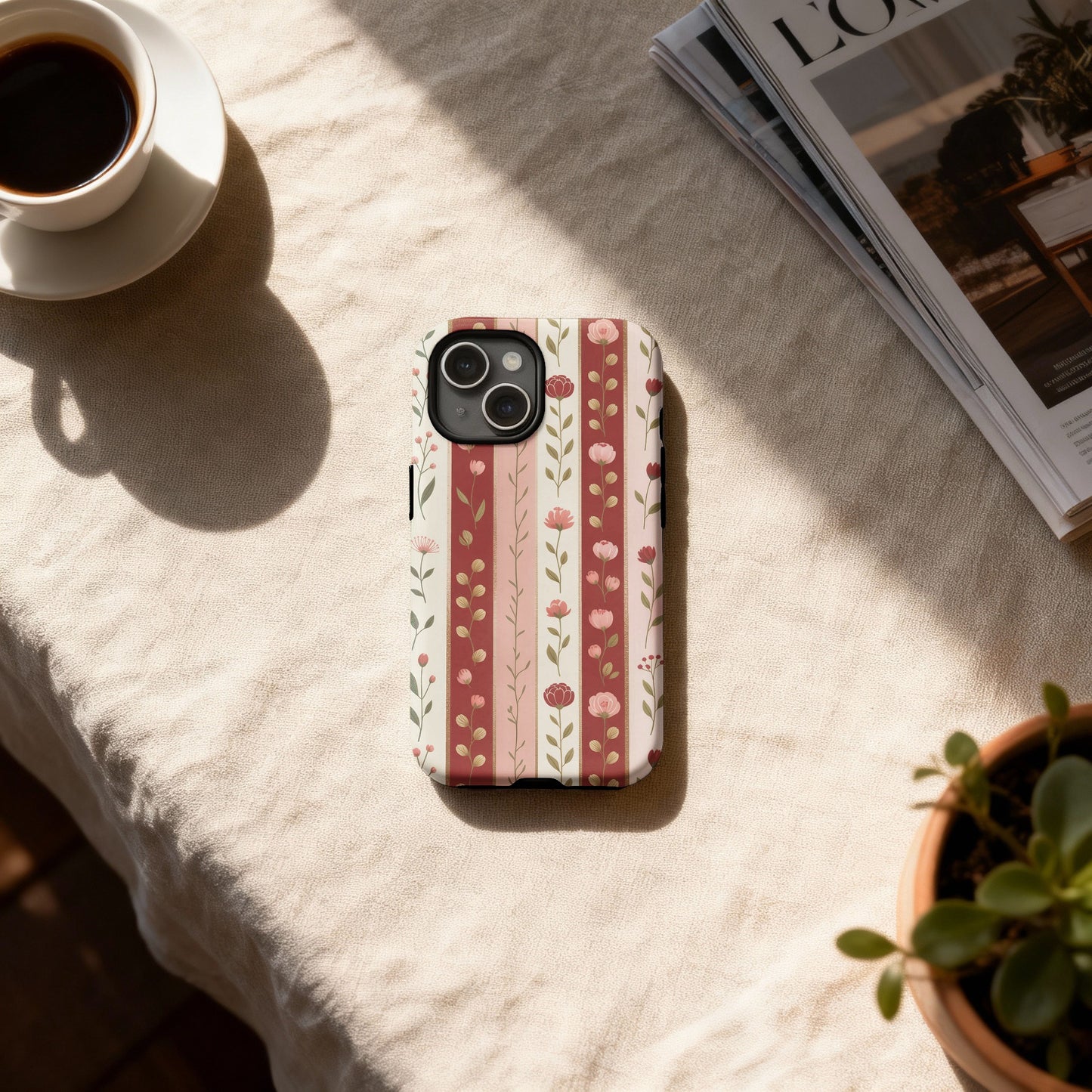 iPhone case with a vertical stripe floral pattern in pink and cream.