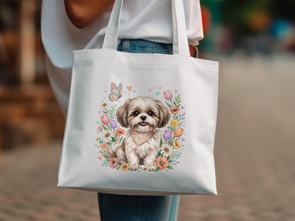White canvas tote bag with a whimsical Shih Tzu and floral illustration.