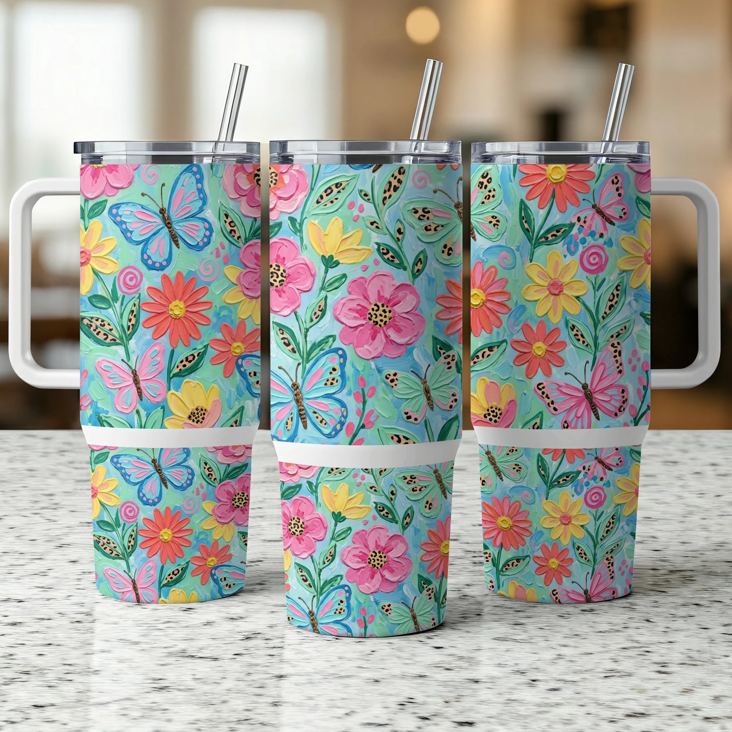 Three tumblers with colorful floral and butterfly patterns and white handles.