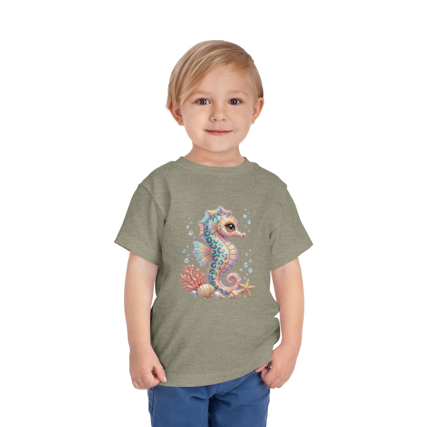 Toddler wearing grey t-shirt with a whimsical seahorse and coral graphic.
