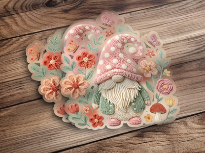Gnome with pink polka dot hat surrounded by flowers and butterflies.