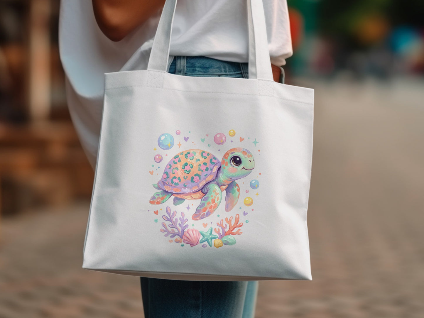 White tote bag with a colorful cartoon sea turtle and coral reef design.