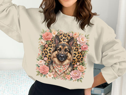 German Shepherd portrait surrounded by floral and leopard print details on a cream sweatshirt.