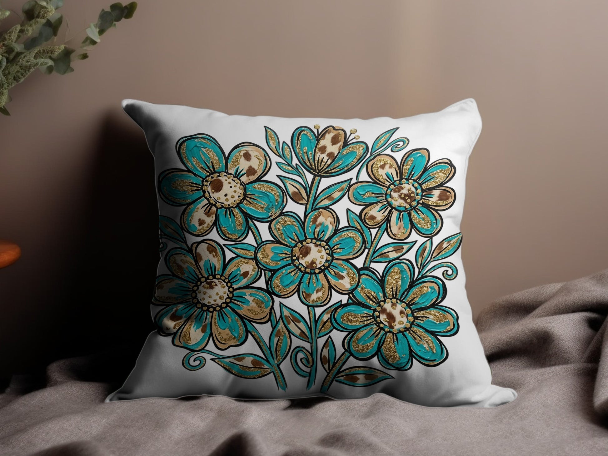 White throw pillow with teal and gold floral pattern.