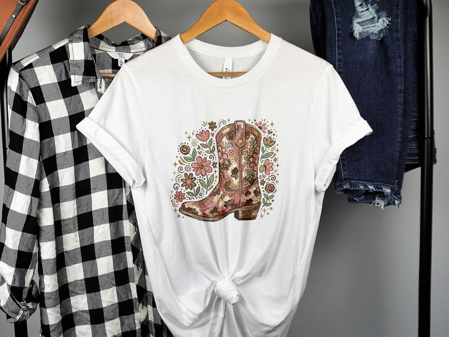 White t-shirt with a floral cowboy boot graphic.
