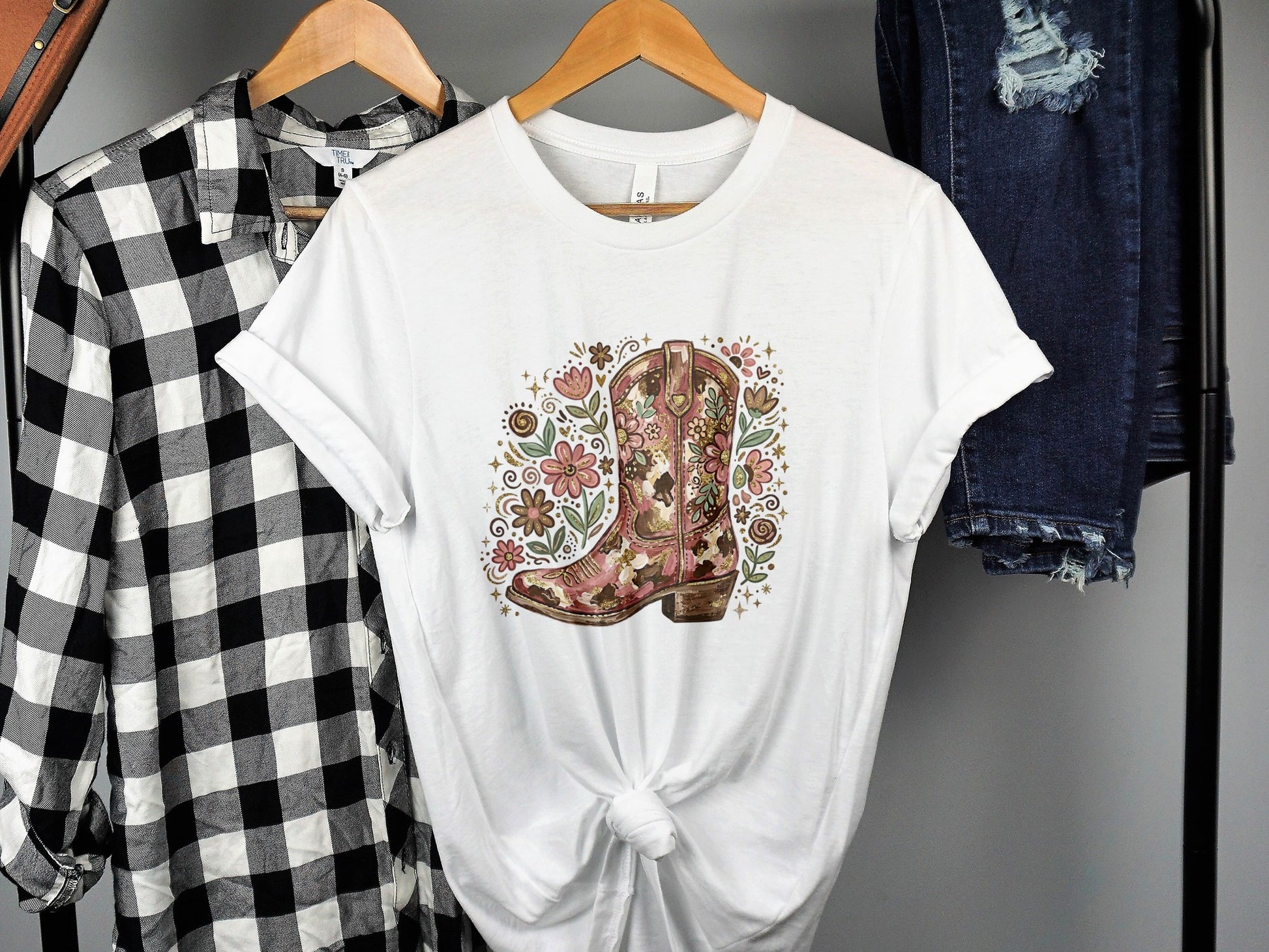 White t-shirt with a floral cowboy boot graphic.
