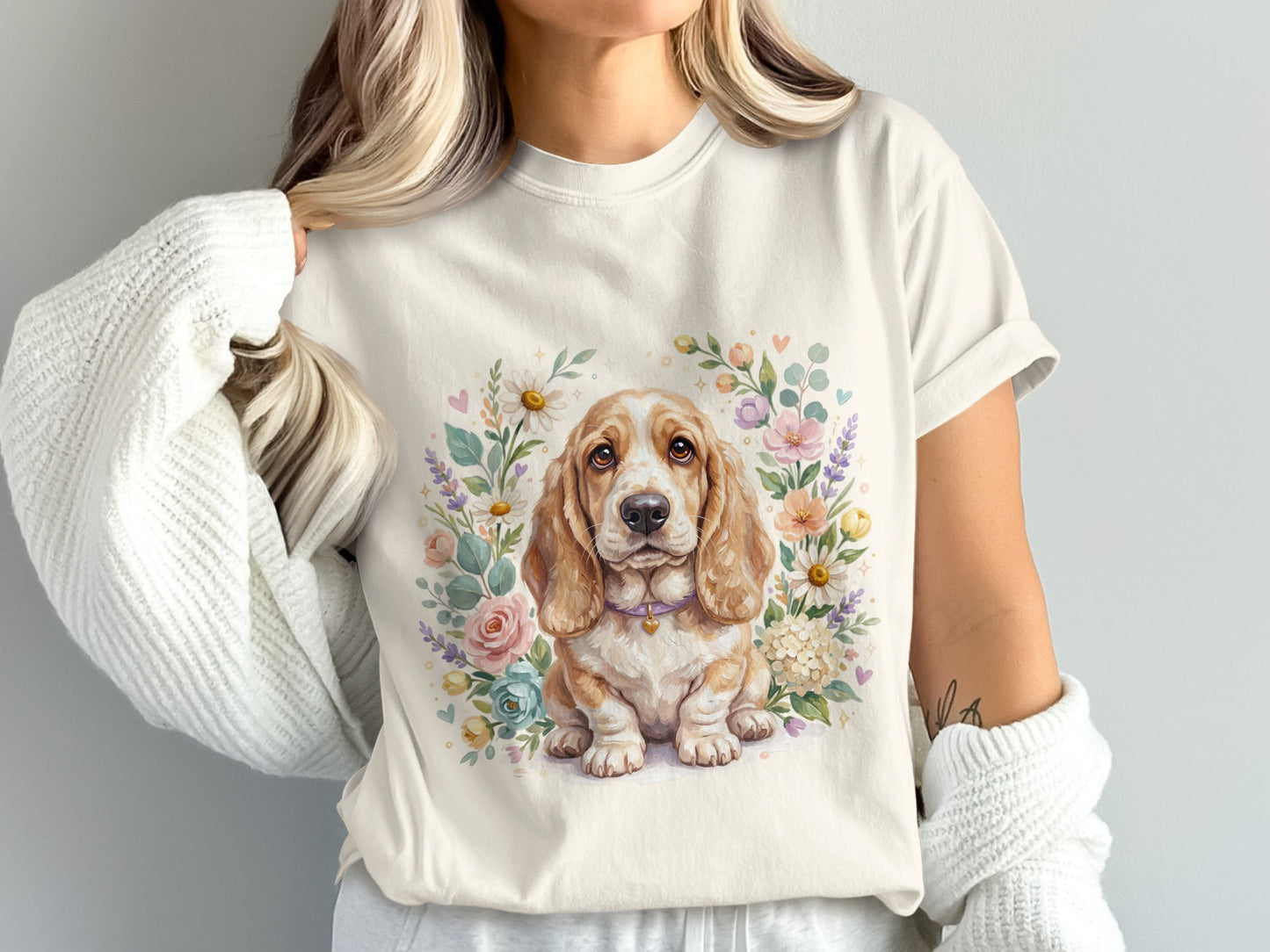 Basset hound puppy with floral wreath on cream t-shirt.