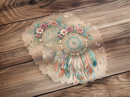 Dreamcatcher with feathers and flowers, on a wooden background.