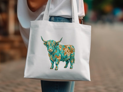 White tote bag with a colorful Highland cow design.