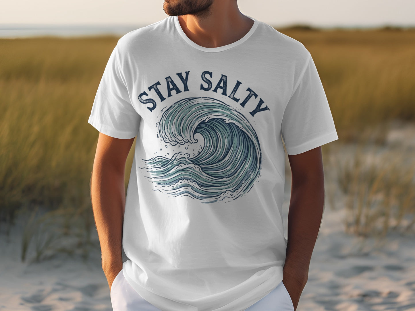 White t-shirt with a blue wave graphic and "Stay Salty" text.