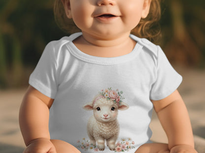 Baby wearing white onesie with cute sheep and floral design.