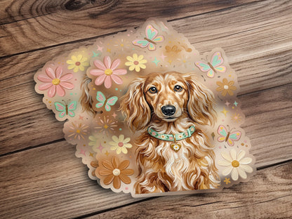 Dachshund wearing a floral collar surrounded by pastel butterflies and flowers.