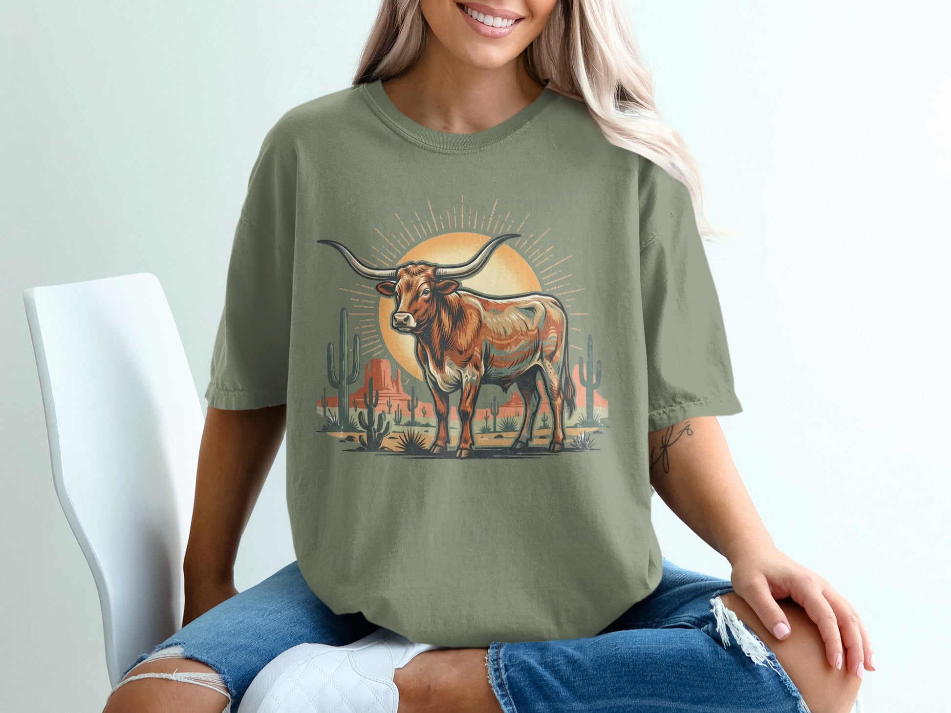 Longhorn bull with large horns in a desert landscape with cacti.