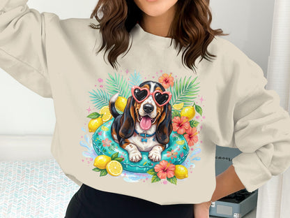 Basset hound in heart sunglasses floats on a pool float with lemons and hibiscus.