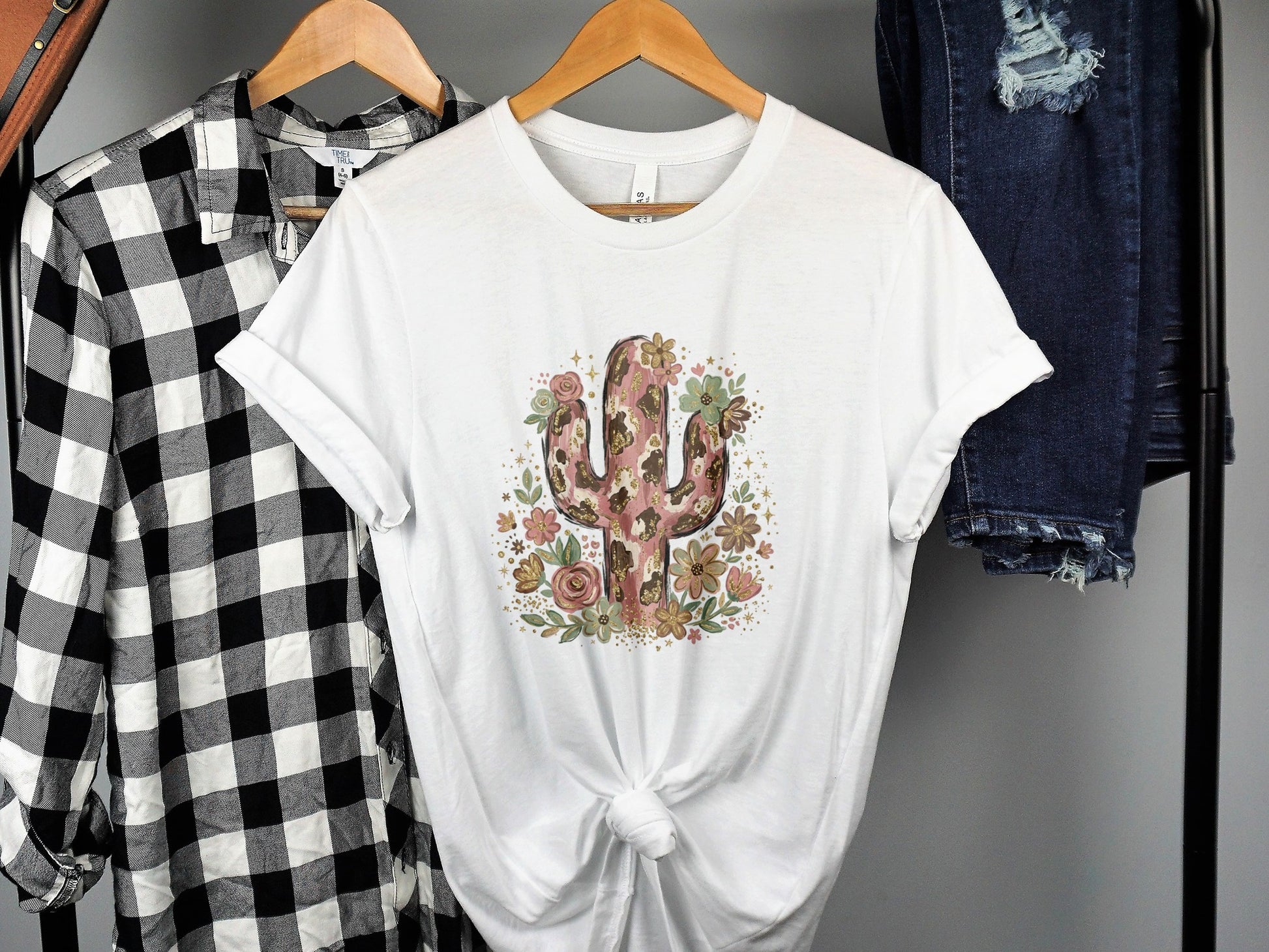 White t-shirt with a pink floral cactus design and cheetah print accents.