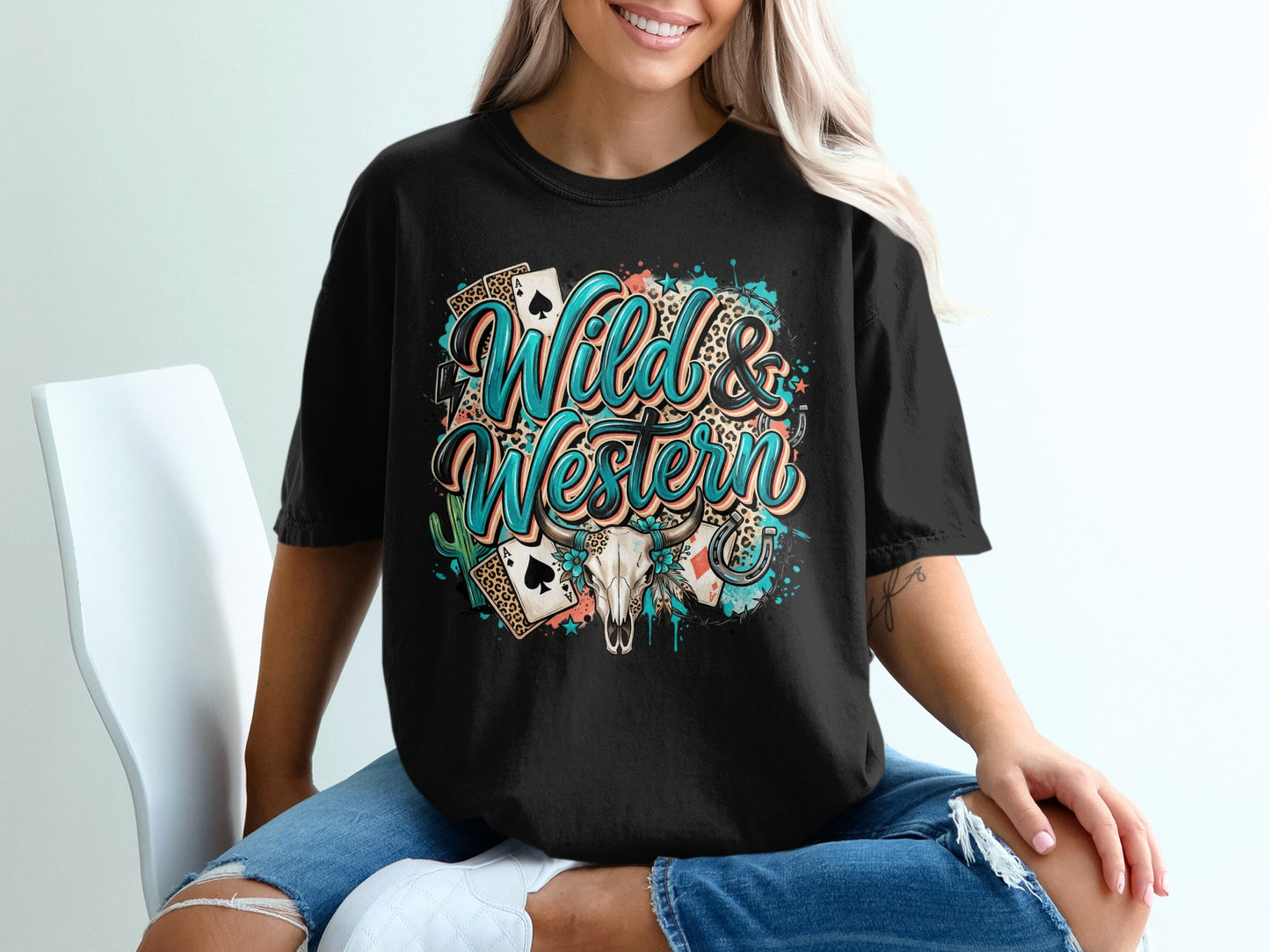 Black t-shirt with "Wild & Western" text, playing cards, cactus, and skull design.