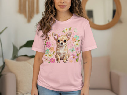 Chihuahua wearing a pink bow on a pink t-shirt with floral and butterfly accents.