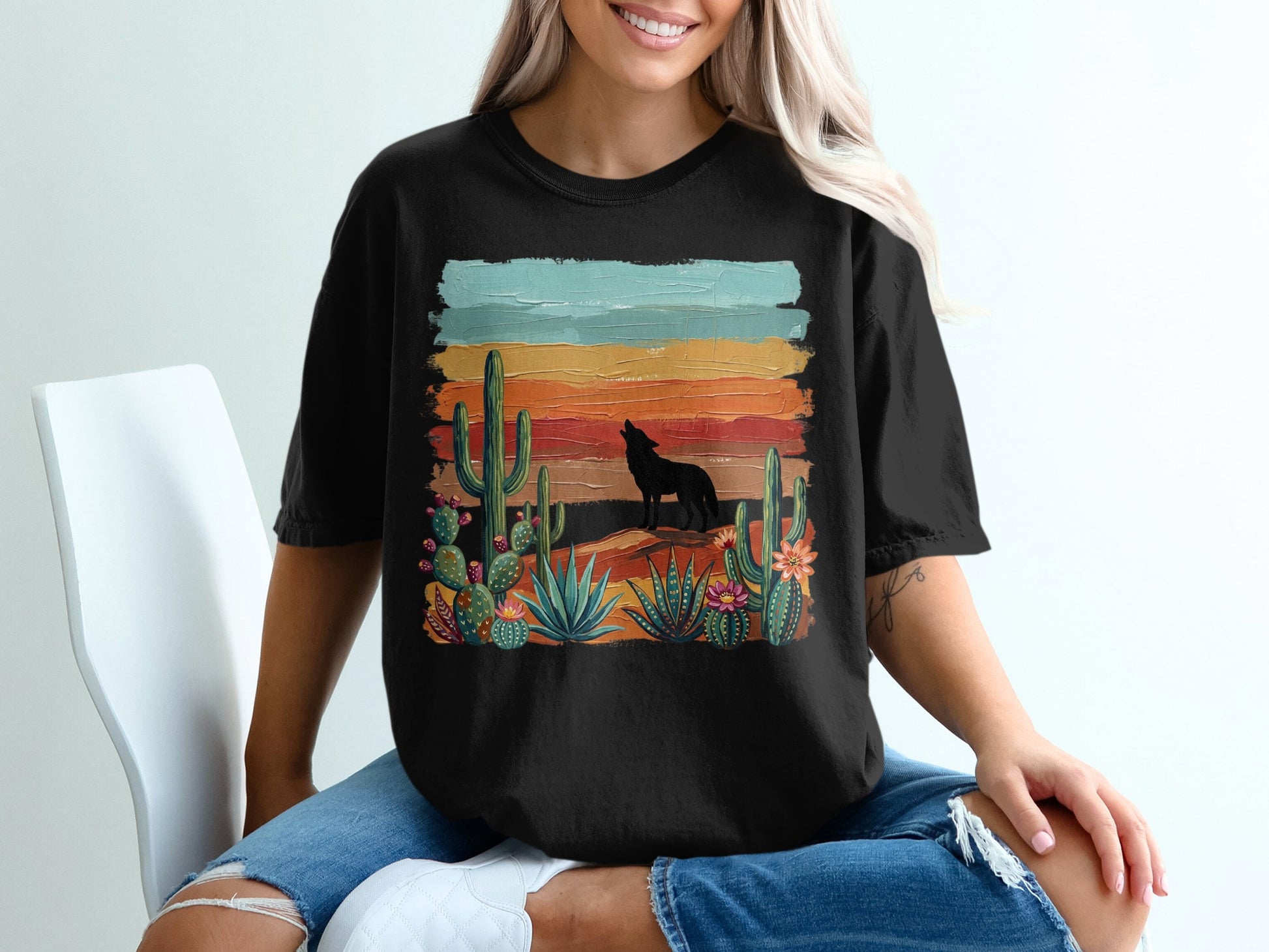Black t-shirt with desert sunset scene, wolf silhouette and cacti.