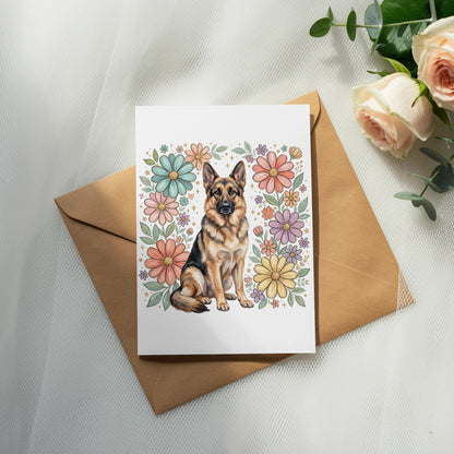 German Shepherd sits surrounded by a floral border on a greeting card.
