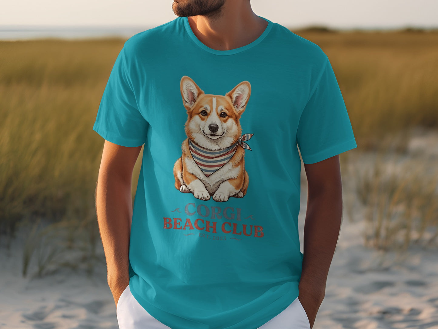 Teal t-shirt featuring a corgi wearing a bandana and "beach club est. 2023" text.