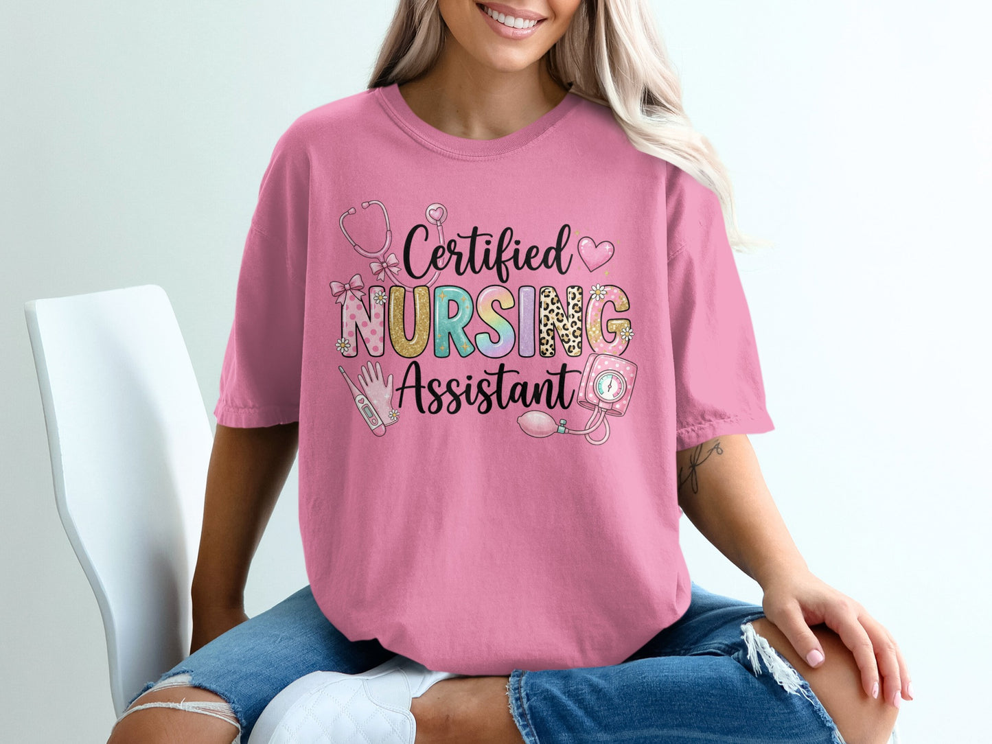 Pink t-shirt with "Certified Nursing Assistant" text and medical icons.