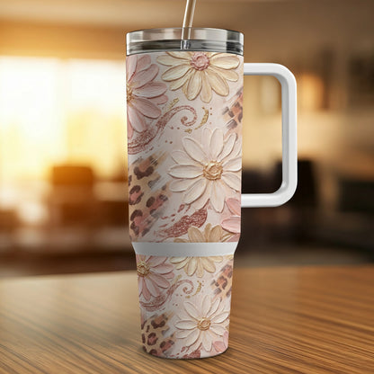 Pink floral and leopard print insulated tumbler with white handle and straw.