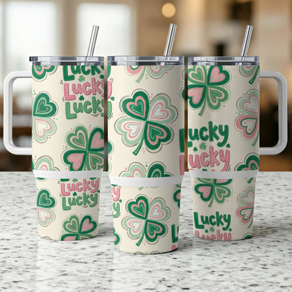 Three tumblers with clover and "Lucky" pattern on a speckled countertop.