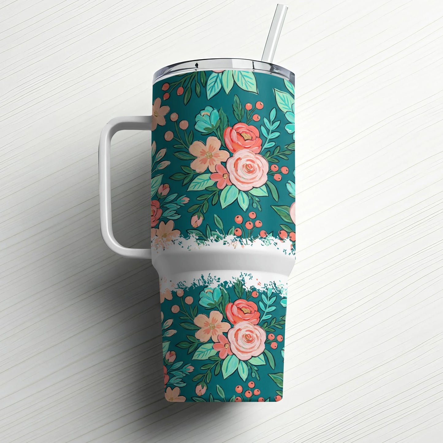 Teal tumbler with floral pattern and white handle, includes straw.