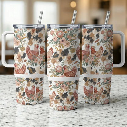 Three tumblers with chicken and floral designs on a counter.